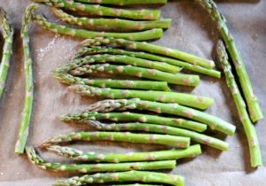 fresh asparagus on baking tray